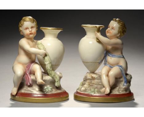 A PAIR OF ROYAL WORCESTER GLAZED PARIAN RAPHAELESQUE COLOURED FIGURES OF A BOY OR GIRL HOLDING AN AMPHORA, MODELLED BY JAMES 
