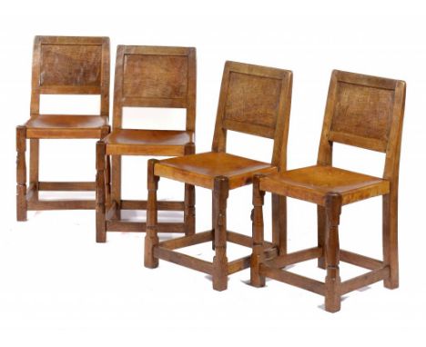 A SET OF FOUR MOUSEMAN OAK DINING CHAIRS, SECOND HALF 20TH CENTURY with adzed panel back and tan hide seat, 85cm h, carved mo