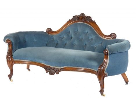 A VICTORIAN MAHOGANY SOFA, C1860 of serpentine form, the arched back carved with leafy scrolls and centred by a cabochon,  90