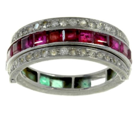 A RUBY AND EMERALD REVERSIBLE COCKTAIL RING  set with calibre cut rubies and emeralds between diamond wings, in platinum, 5.9