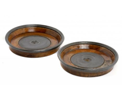 A PAIR OF PEWTER MOUNTED AND TURNED FRUITWOOD WINE COASTERS, EARLY 19TH C with engine turned centre and moulded rim, 15cm dia