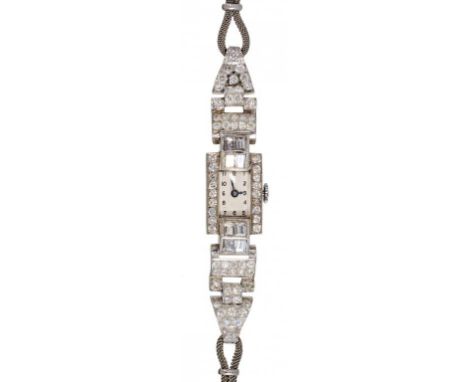 AN ART DECO DIAMOND COCKTAIL WATCH  of rectangular design and pavé set, the lugs with baguette cut diamonds, in white gold, u