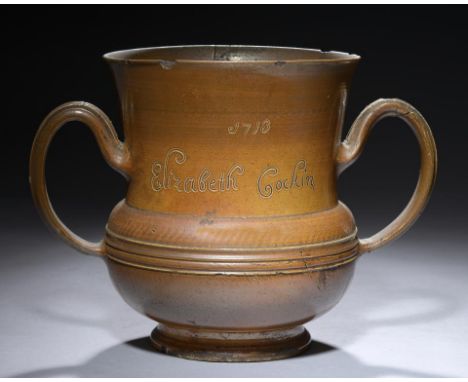 AN EARLY NOTTINGHAM OR CRICH  SALTGLAZED BROWN STONEWARE LOVING CUP,  DATED 1713  finely potted and of compressed  bulbous fo