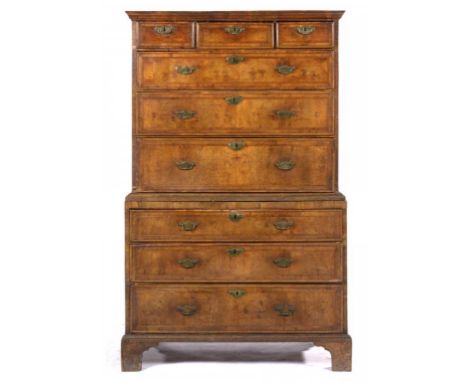 A GEORGE II WALNUT AND FEATHER BANDED CHEST ON CHEST, C1740  with moulded cornice and fitted with nine moulded drawers with b