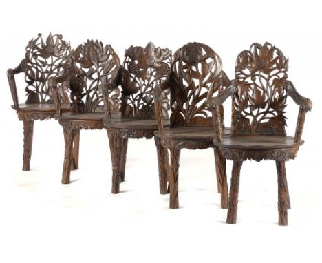 AN EXTRAORDINARY SET OF FIVE CONTINENTAL CARVED WOOD ELBOW CHAIRS, LATE 19TH C  of naturalistic form, the back with the initi