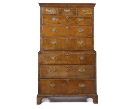 A GEORGE II WALNUT CHEST ON CHEST, C1740  the moulded cornice above three short and three graduated, banded drawers, the lowe