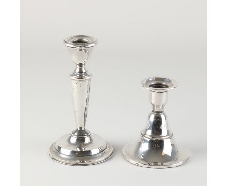 Two silver candlesticks, 835/000, on round foot.&nbsp;A low candlestick and a slightly higher one with a baluster-shaped colu