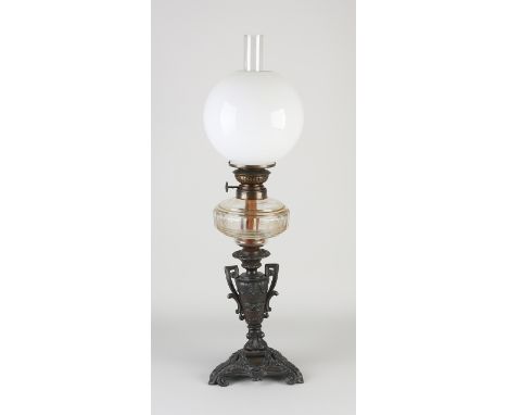 Antique composition metal kerosene lamp with crystal glass reservoir.&nbsp;Circa 1900. Dimensions: H 55 cm.&nbsp;In good cond