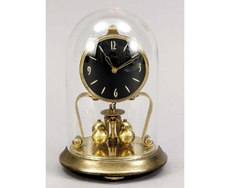 Small German brass year mantel clock under a bell jar.&nbsp;Marked Core.&nbsp;Circa 1960. Dimensions: H 18 cm.&nbsp;In good c