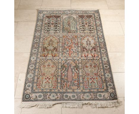 Hand-knotted Ghoum/Iran rug.&nbsp;Dress is made entirely of silk, very finely knotted.&nbsp;Light in color with nine compartm