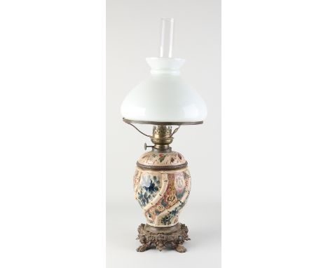 Antique majolica kerosene lamp with composition metal base.&nbsp;Floral decor.&nbsp;Historicism.&nbsp;Dimensions: H 65 cm.&nb