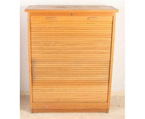 Oak filing cabinet with roller shutter, with various drawers behind it.&nbsp;Circa 1930 - 1950. Dimensions: 114 x 92 x 40 cm.