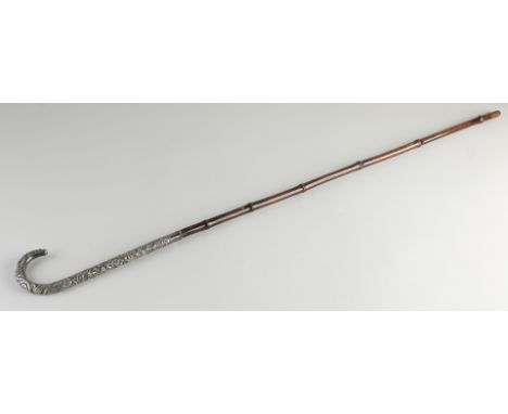 Walking stick with bamboo and a silver handle, richly decorated with floral decor with birds and dragon.&nbsp;Presumably Mark