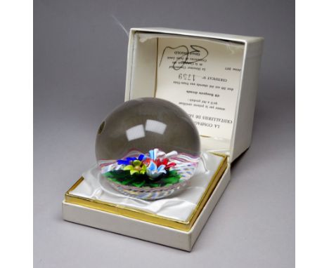 A St. Louis glass paperweight - multicoloured on latticinio ground, clear encased globe, monogram and dated 1977 to central f