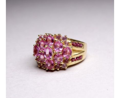 A 9ct yellow gold and pink topaz dress ring - cluster set stone with further to the shanks, ring size K, weight 5.1g.