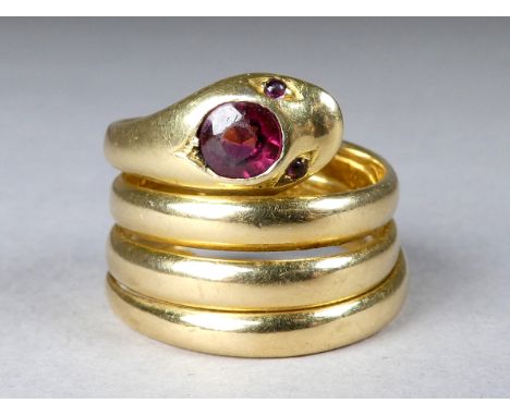 An 18ct yellow gold garnet set ring - fashioned in the form of a snake, size K, weight 10g.