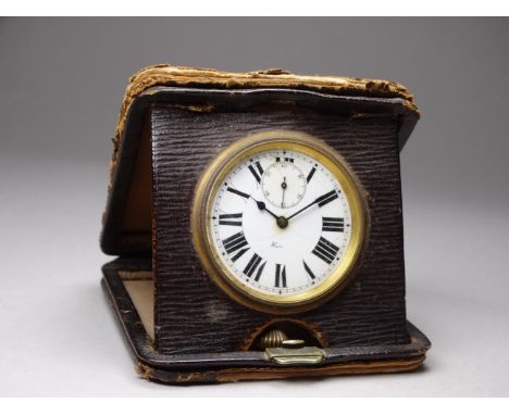 An early 20th century leather cased travelling clock - with a white enamel dial set out in Roman numerals.