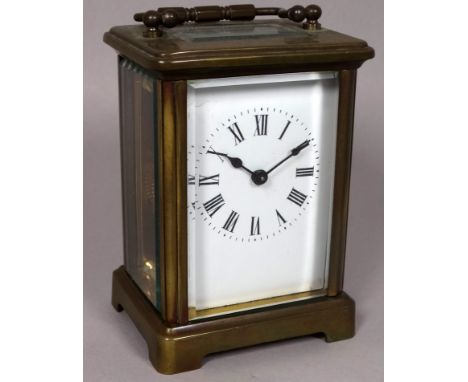 A 20th century brass carriage timepiece - the white enamel dial set out in Roman numerals, height 12cm. 