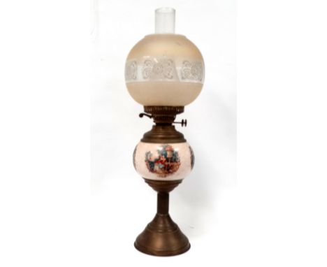 An early 20th century ceramic and brass oil lamp - with an etched glass globe shaped shade, height 60cm.