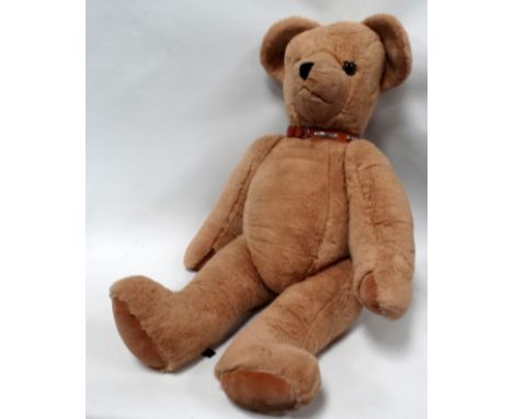 A large articulated teddy bear - with brown suede paws and brown leather studded collar with bell, height 100cm.