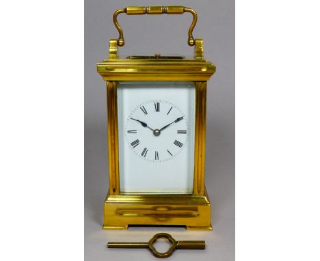 An early 20th century repeating carriage clock - with brass corniche case and bevelled glass plates, the enamel dial set out 