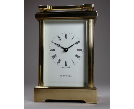 A 20th century carriage timepiece - retailed by H Samuel, the brass corniche case with four bevelled plates, the white enamel