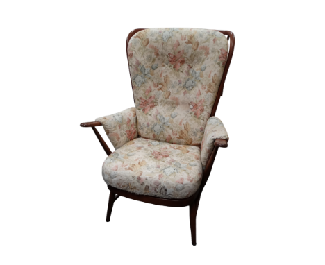 A stained beechwood upholstered armchair by Ercol - covered in a floral fabric with a stickback and raised on turned tapering