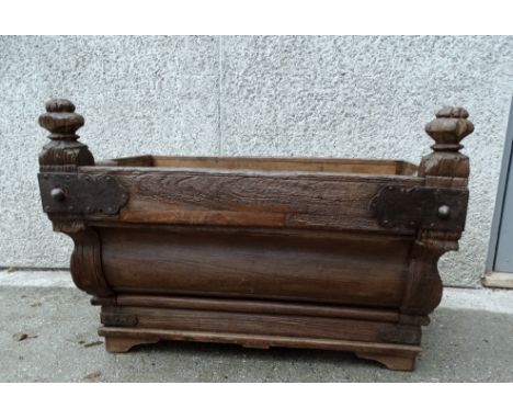 A continental hardwood trough - with a sloping moulded front, octagonal terminals and wrought metal brackets, 68cm, 54cm, 60c