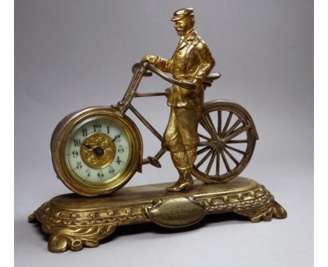 A novelty brass desk timepiece by The British United Clock Company - in the form of a gentleman standing next to an ordinary 