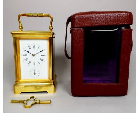 A 20th century carriage alarm clock - with a brass corniche case and white enamel dial, the movement fitted with a bell, heig