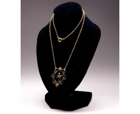 A Belle Epoque 9ct yellow gold pendant - set with amethyst and seed pearls, on a 9ct yellow gold fine link chain.