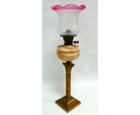 A late 19th century brass and glass oil lamp - with marbled reservoir and pink trimmed etched glass shade above a brass Corin