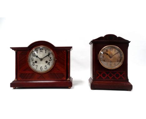 An Edwardian mahogany and walnut mantel clock - the silver dial set out with Arabic numerals and flanked by columns, the move