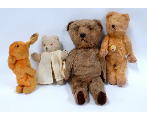 An early 20th century plush teddy bear - circa 1932, possibly Merrythought with glass eyes, stitched nose, velvet pads and fi