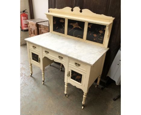 An Aesthetic movement dressing table, the upstand having thee black japanned panels, marble top over three drawers, the kneeh