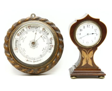 An oak cased barometer, and an Edwardian inlaid balloon clock