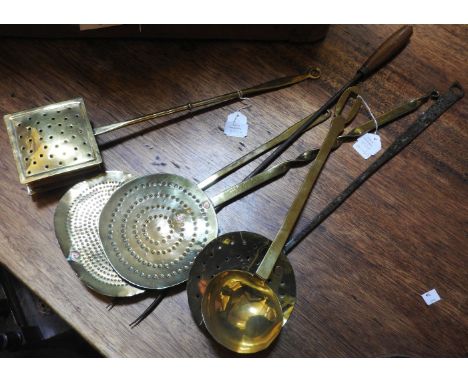 Three 19th century brass and iron skimmers, a spoon, chestnut roaster and toasting fork