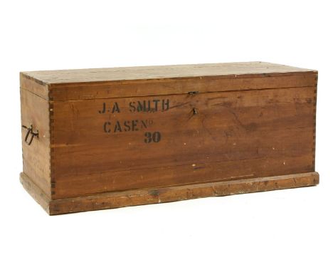 A large pine trunk of rectangular form, fitted twin wrought iron carrying handles, the front inscribed J. A. Smith, case no. 