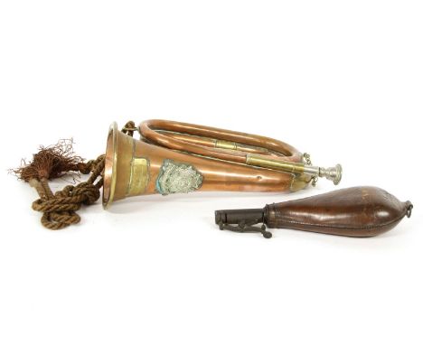 A copper and brass military bugle, by Haing, with Bedfordshire and Hertfordshire insignia, together with a leather powder fla