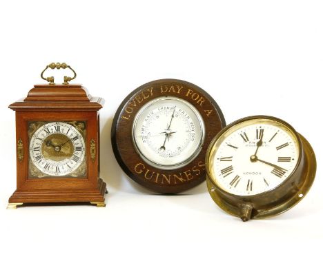 A reproduction table clock by Biddle and Mumford, London, a Guinness aneroid barometer, and a further cased clock