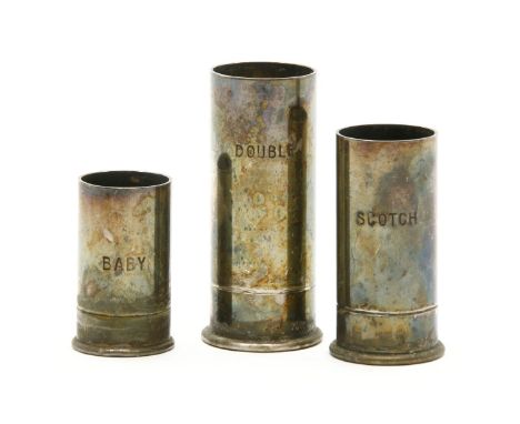 A set of three silver plated whisky measures, formed as shotgun cartridges, inscribed 'Double', 'Scotch' and 'Baby', tallest 