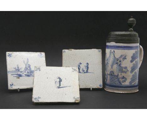 A Continental faience tankard, pewter mounted, with initials 'BM 1789', cracked, 23cm high, and three Delft tiles, one with f