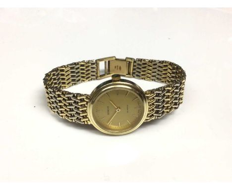 14ct gold Geneve Quartz wristwatch with a circular gold coloured dial and baton markers in gold case, measuring 23mm diameter