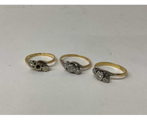 Three 18ct gold diamond three stone rings, each with three small diamonds in platinum illusion setting, ring sizes Q 1/2, N a