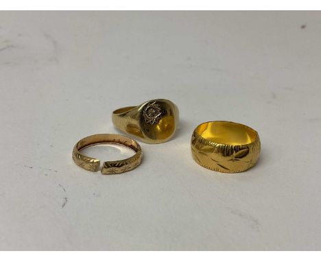 22ct gold wedding band (London 1971), together with a 9ct gold wedding band (cut) (London 1966) and a 9ct gold signet ring (3