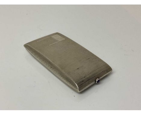 George V silver cigarette case of rectangular form with engine turned decoration, gem set button and gilded interior, (Birmin