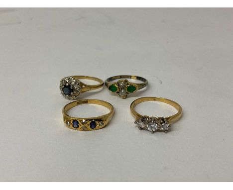 18ct gold diamond three stone ring, together with three other 18ct gold and gem-set dress rings (4)Total gross weight 10.8 gr