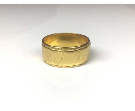 22ct gold wide band wedding ring with engraved geometric decoration (London 1968). Ring size NWeight 6.3 grams