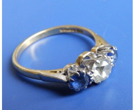 A three stone diamond & sapphire ring, the central old cut diamond approximately .75 carat 