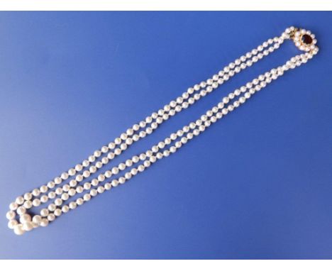 A double strand graduated pearl necklace with 9ct gold cluster clasp having central garnet, 18” 